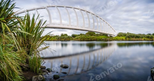 Preview: Beautiful view of the Te Rewa Rewa Bridge under a cloudy blue sky in New Plymouth, New Zealand