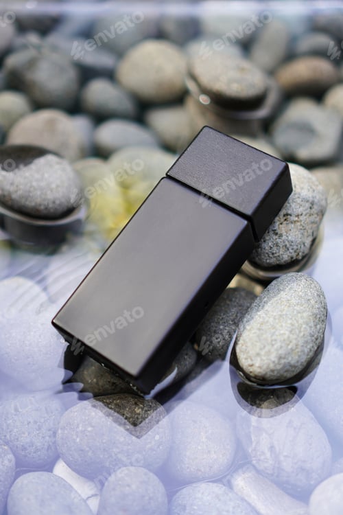 Preview: Black Rectangular Bottle on Pebbles in Water