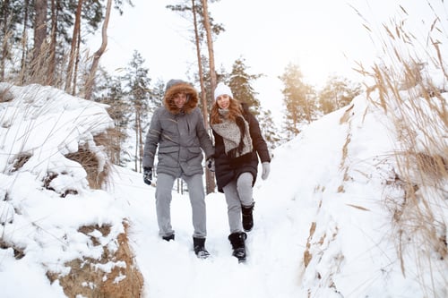 Preview: Happy couple walking winter forest. Man and woman relationship