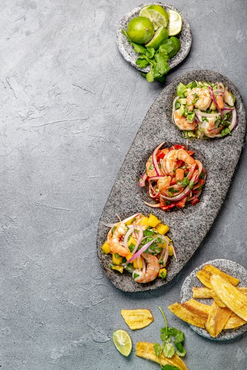 Preview: Three colorful shrimps ceviche with mango, avocado and tomatoes.