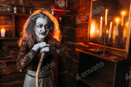 Preview: Scary witch with a cane at the mirror and candles