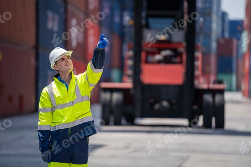 Preview: Professional container yard workers checking stock for loading in the container yard warehouse.