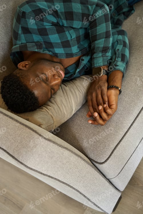Preview: Man fell asleep sweetly on a cozy sofa