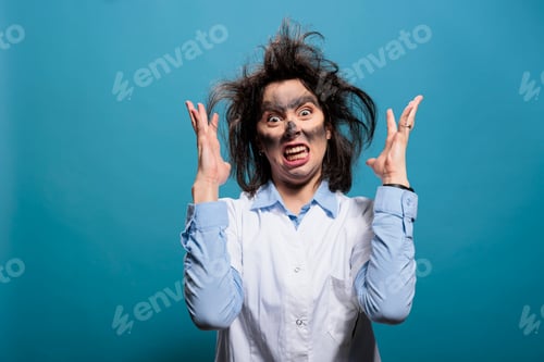 Preview: Mad biochemist with amusing look after laboratory explosion being angry while gesturing with rage