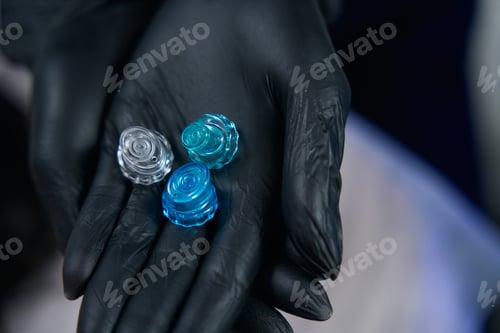 Preview: Professional cosmetologist holding plastic tips, preparing instruments for work