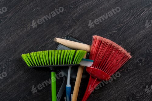 Preview: a brush scoop mop and other bunch of cleaning accessories set flat lay on the floor