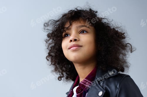 Preview: close-up portrait of little child with curly hair isolated on grey