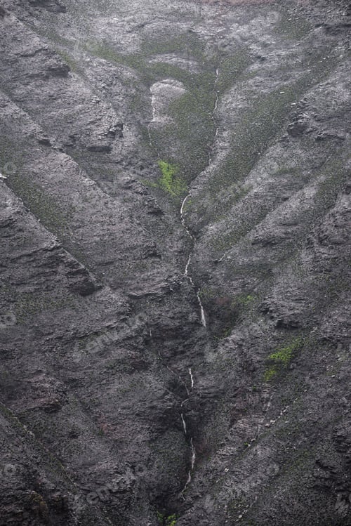 Preview: A stream flows down scorched hillsides after forest fires