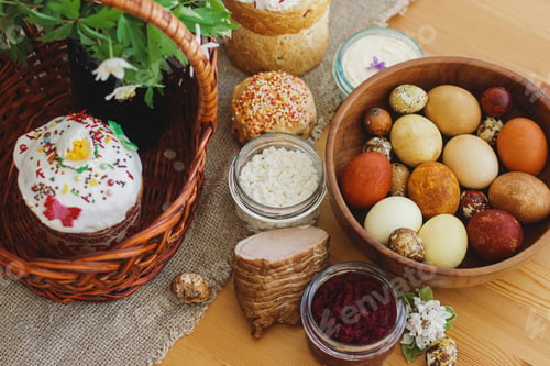 Preview: Traditional Easter food, homemade Easter bread, easter eggs and spring flowers on rustic table