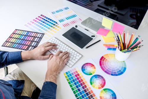 Preview: Male creative graphic designer working on color selection and color swatches