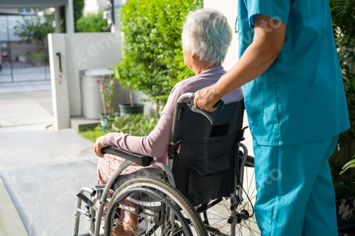 Preview: Caregiver help and care Asian senior woman patient sitting on wheelchair to ramp in nursing hospital