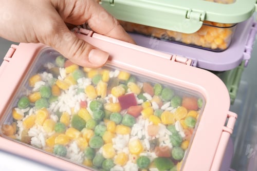 Preview: Woman taking box with vegetable mix from refrigerator, closeup