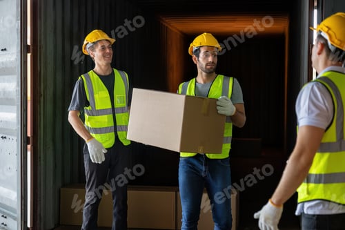 Preview: Worker carry carton box taken from 40 feet steel container on the trailer truck park at warehouse