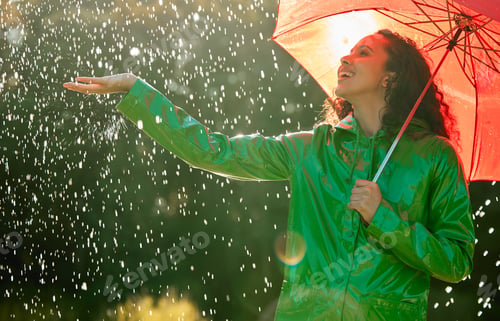 Preview: Shot of a beautiful young woman having fun in the rain