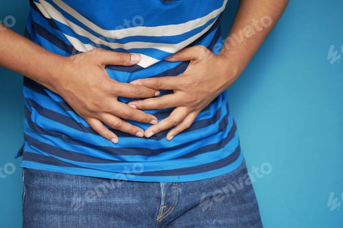 Preview: young man suffering stomach pain close up.