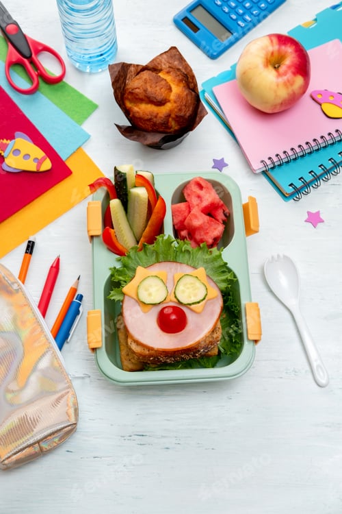 Preview: School lunch box for kids with food in the form of funny faces. Back to school concept