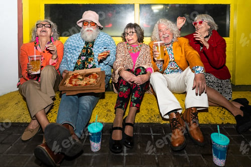 Preview: Group of happy senior friends with fancy clothing having party in the night