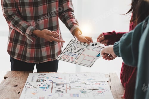 Preview: Close up ux developer and ui designer brainstorming interface wireframe design.Creative digital