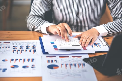 Preview: businessman or accountant who are using a calculator to calculate business data Accounting documents