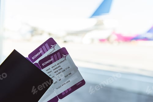 Vista previa: close up of air tickets and travel bag in airport