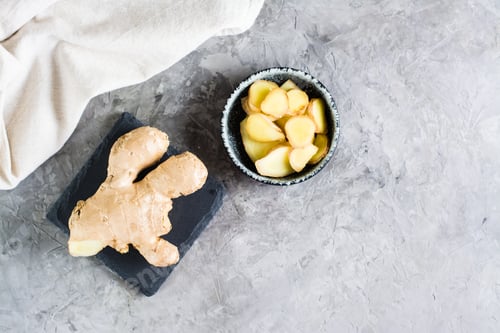 Preview: Sliced fresh raw ginger root in a bowl on the table. Alternative medicine. Top view