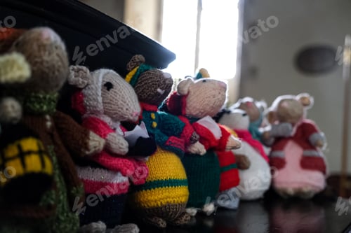 Preview: Knitted handmade mice in row in colourful clothes. DIY