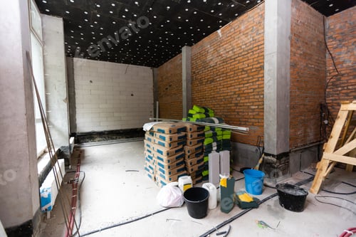 Preview: Newly renovated generic empty office space with leftover materials and ladder in foreground