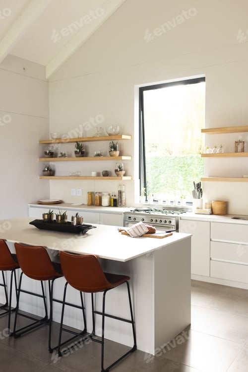 Preview: A modern kitchen features white cabinetry, a central island with bar stools, and open shelving with