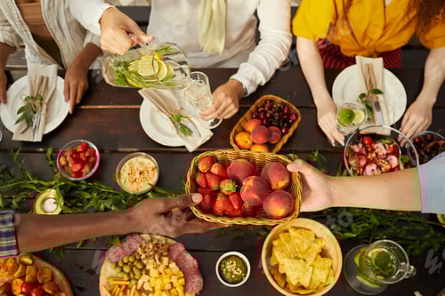 Preview: Friends at Summer Dinner Table Above View