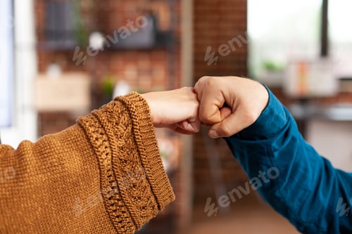 Preview: Closeup of colleagues greeting giving first bump during covid19 pandemic