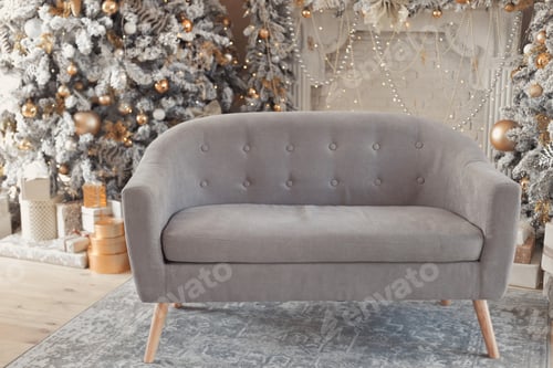 Preview: Gray suede sofa between two luxury decorated snow-covered trees in pastel colors in apartment