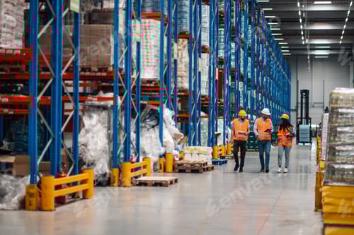 Preview: Warehouse workers walking and discussing logistics in a storage facility