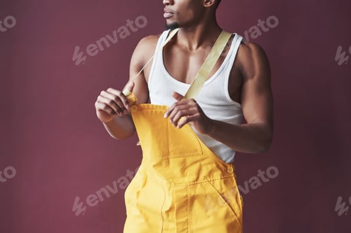 Preview: In his new house. Young african american worker in the yellow uniform have some job