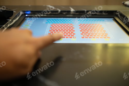Preview: Close up of finger on monitor for choose a movie seat during the movie ticket at box office