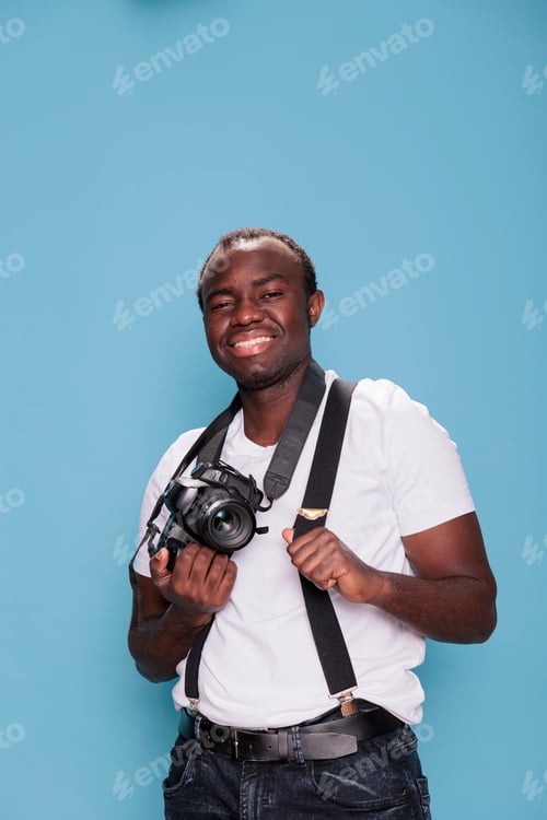 Preview: Handsome confident professional photographer posing while smiling joyfully