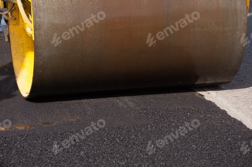 Preview: Pavement machine laying fresh asphalt or bitumen on top of the gravel