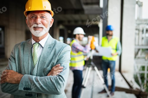 Preview: Engineer and construction site manager dealing with blueprints and plans