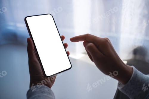 Preview: Mockup image of a woman holding and pointing finger at mobile phone with blank white desktop screen