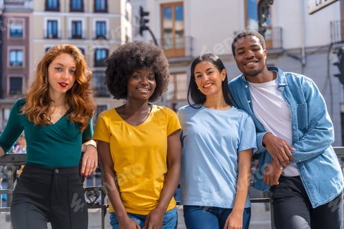 Preview: Portrait of happy multiethnic friends on city street, laughing together outdoors