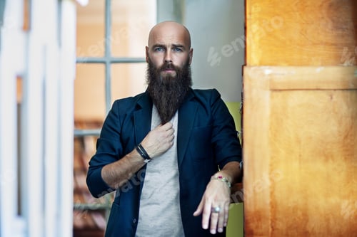 Preview: Portrait of bearded thoughtful man strokes beard