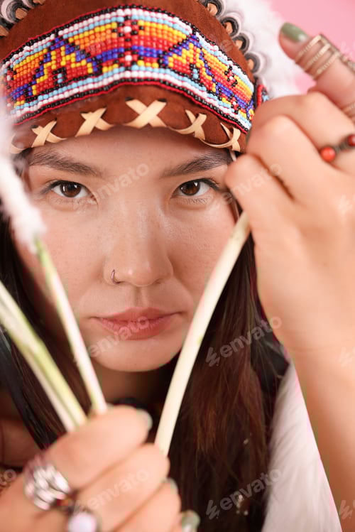 Preview: Shaman woman in native American Indian headdress with bow and arrows, closeup