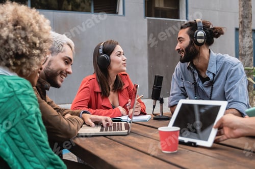 Preview: Multiracial people live streaming podcast outdoor - Focus on center girl talking on microphone