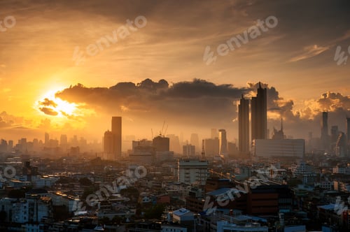 Preview: Golden sunrise shining on high rise modern office building in downtown at Bangkok city