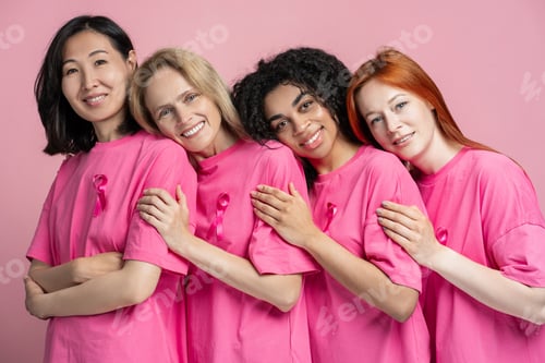 Preview: Diverse group of women embracing in pink for breast cancer awareness