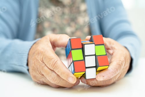 Preview: Alzheimer disease AD, Asian elderly woman patient playing Rubik cube game to practice brain training