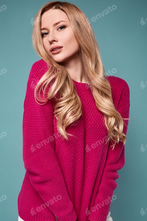 Preview: Portrait Of Beautiful Cute Blond Woman In Purple Sweater On Bright Background In Studio