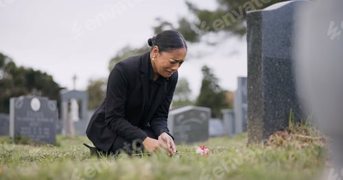 Preview: Sad woman, graveyard and crying with rose by tombstone in mourning, loss or grief at funeral or cem