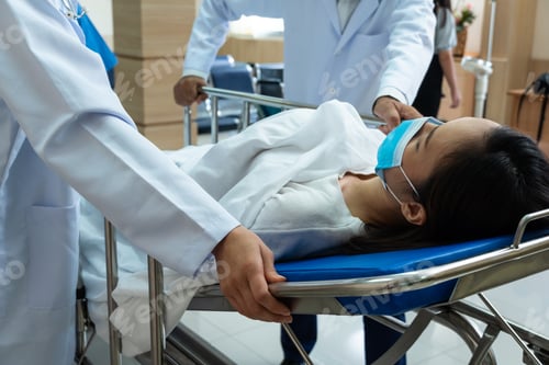 Preview: Medical staff pushing patient on bed to emergency room