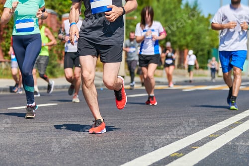 Preview: Marathon runners on city road.