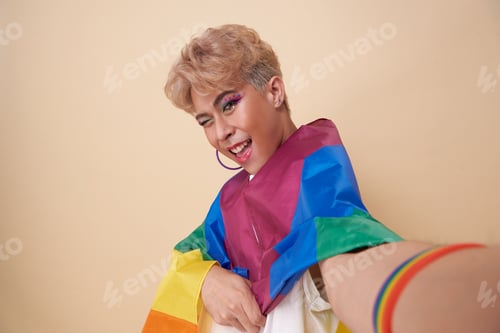 Preview: Youth asian transgender LGBT holding smart phone in hand shooting selfie on front camera